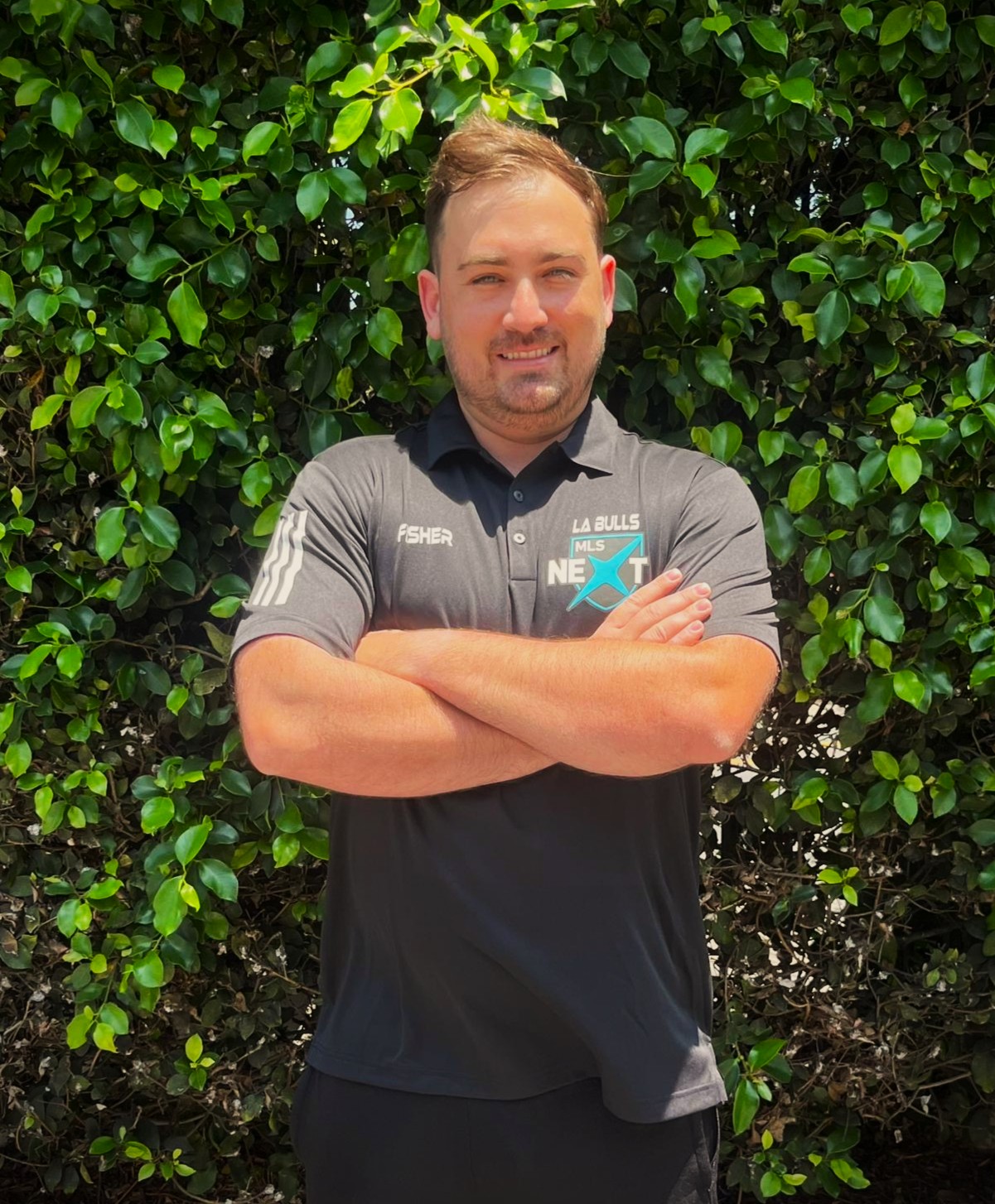 Doug Fisher Headshot Image of a male in MLS Next logo shirt