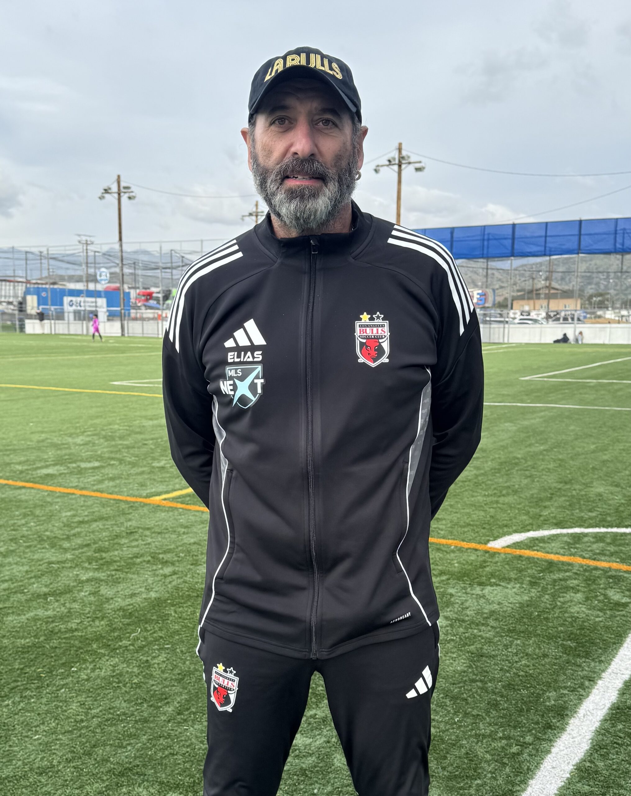 Image of man with a soccer field in the background