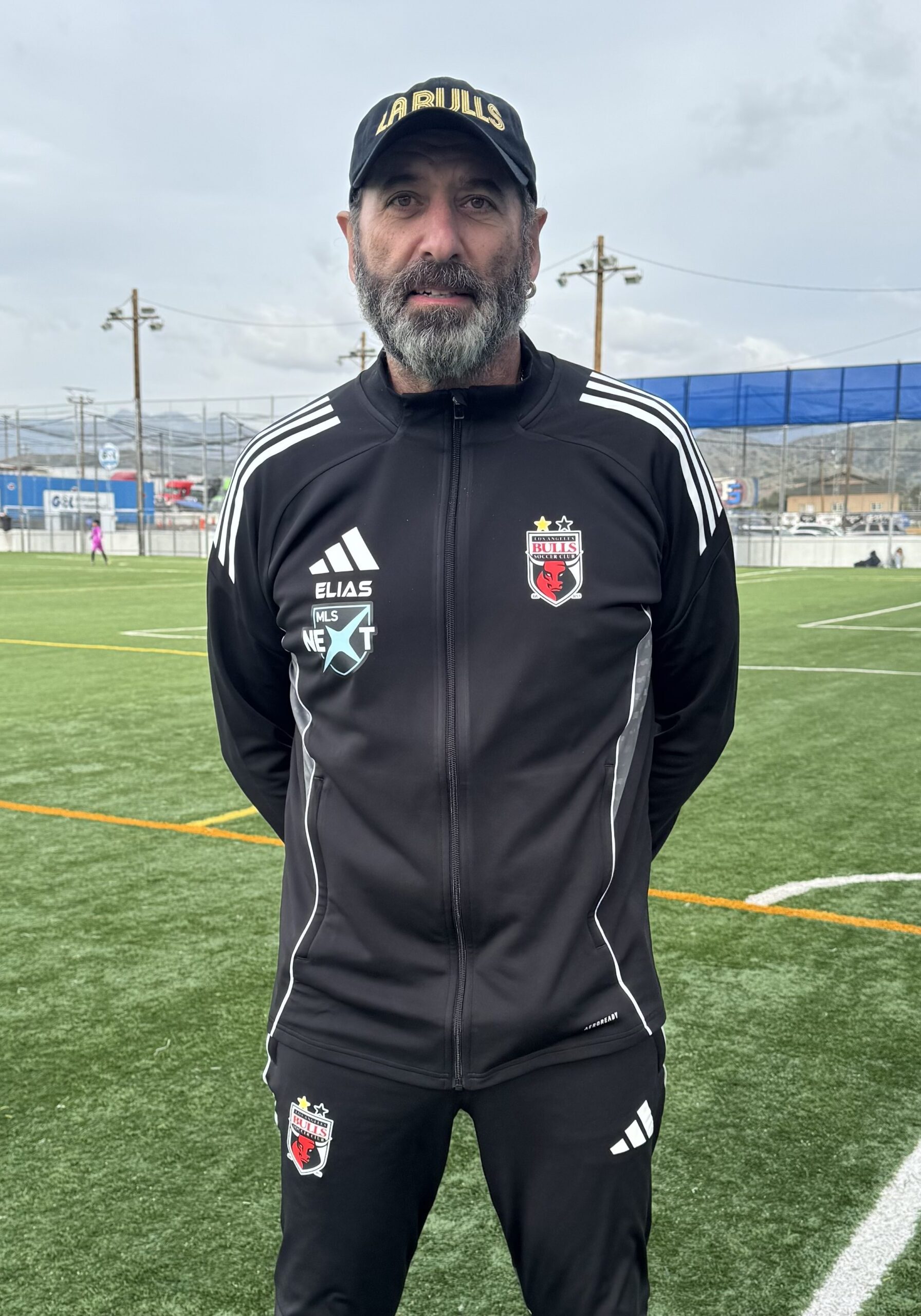 Image of man with a soccer field in the background
